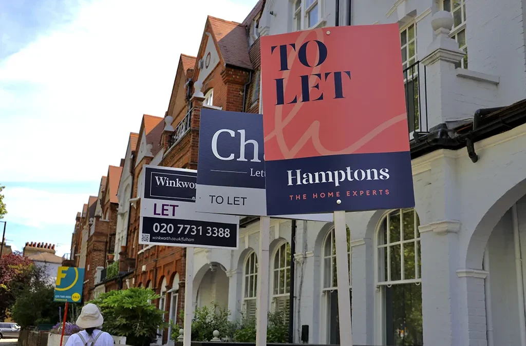 street of houses with for sale sign